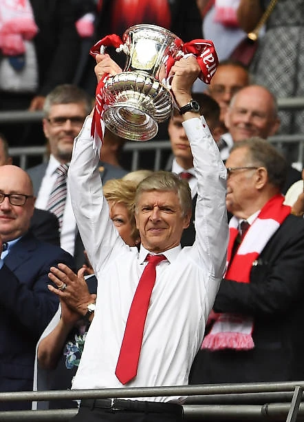 Arsene Wenger Manager of Arsenal lifts the FA Cup Trophy after The Emirates FA Cup Final between Arsenal and Chelsea at Wembley Stadium on May 27...