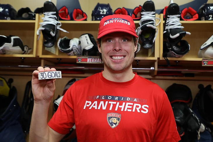 Florida Panthers forward Carter Verhaeghe poses with his 30-goal puck. It is the first time in his NHL career he has hit the mark.