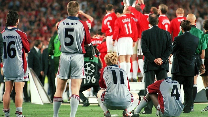 The Bayern players can only watch as United lift the trophy