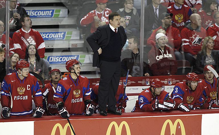 Russia's head coach Valeri Bragin stands on the boards after a collision between his goalie Andrei Makarov and Sweden's Rickard Rakell in the third period of play during the gold medal game of the 2012 IIHF U20 World Junior Hockey Championship in Calgary, Alberta, January 5, 2012. REUTERS/Andy Clark (CANADA  - Tags: SPORT ICE HOCKEY)