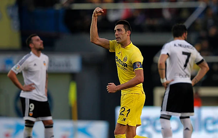 Villarreal's midfielder Bruno Soriano celebrates after scoring during the Spanish league football match Villarreal CF vs Valencia CF at El Madrigal...