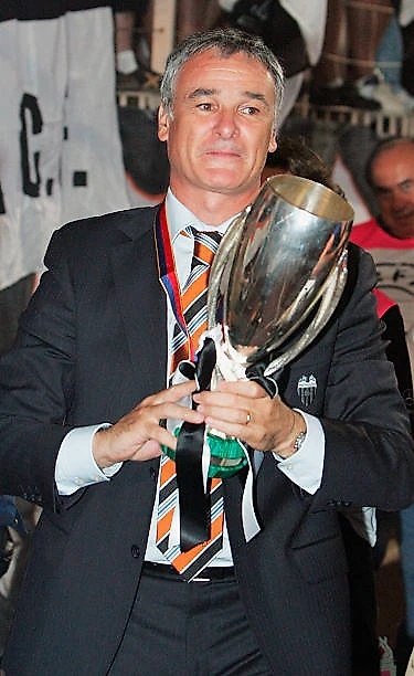 The Valencia manager Claudio Ranieri holds the UEFA Super Cup after his team defeated Porto in the UEFA Super Cup match at the Stade Louis II on...
