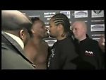 Derek Chisora kisses Carl Baker during a staredown