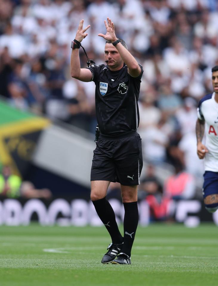 Referee signaling a corner kick.